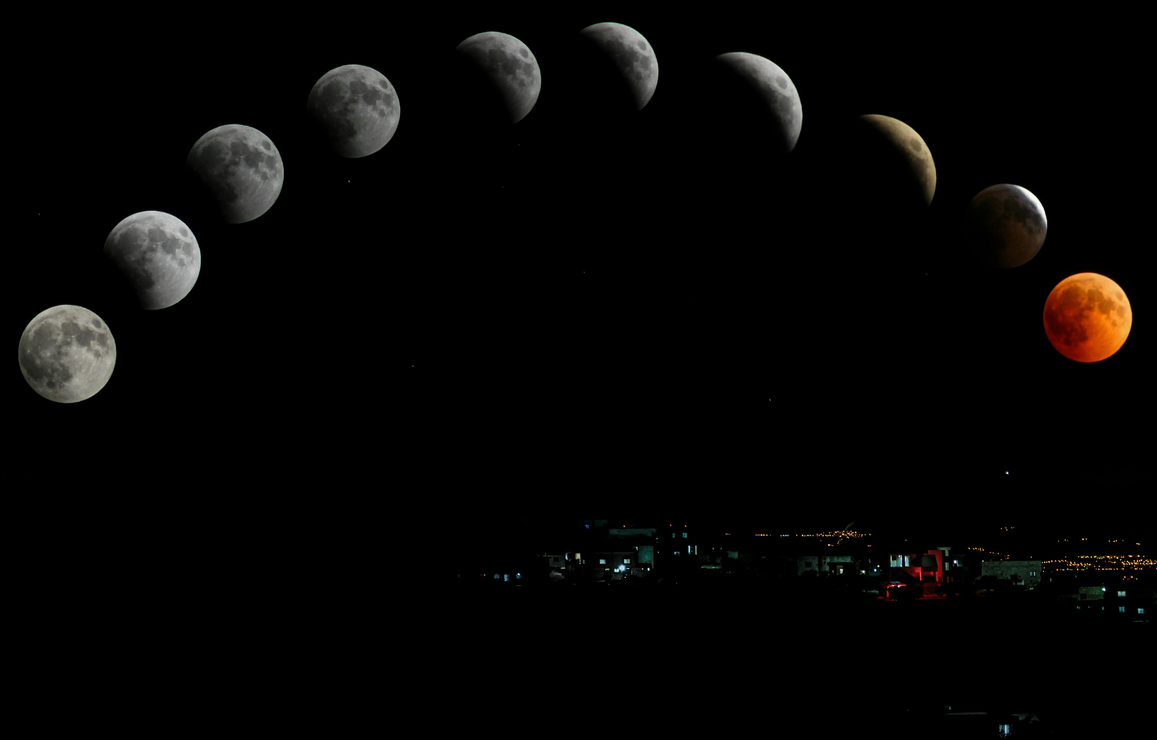 Captivating lunar eclipse sequence featuring blood moon over cityscape.