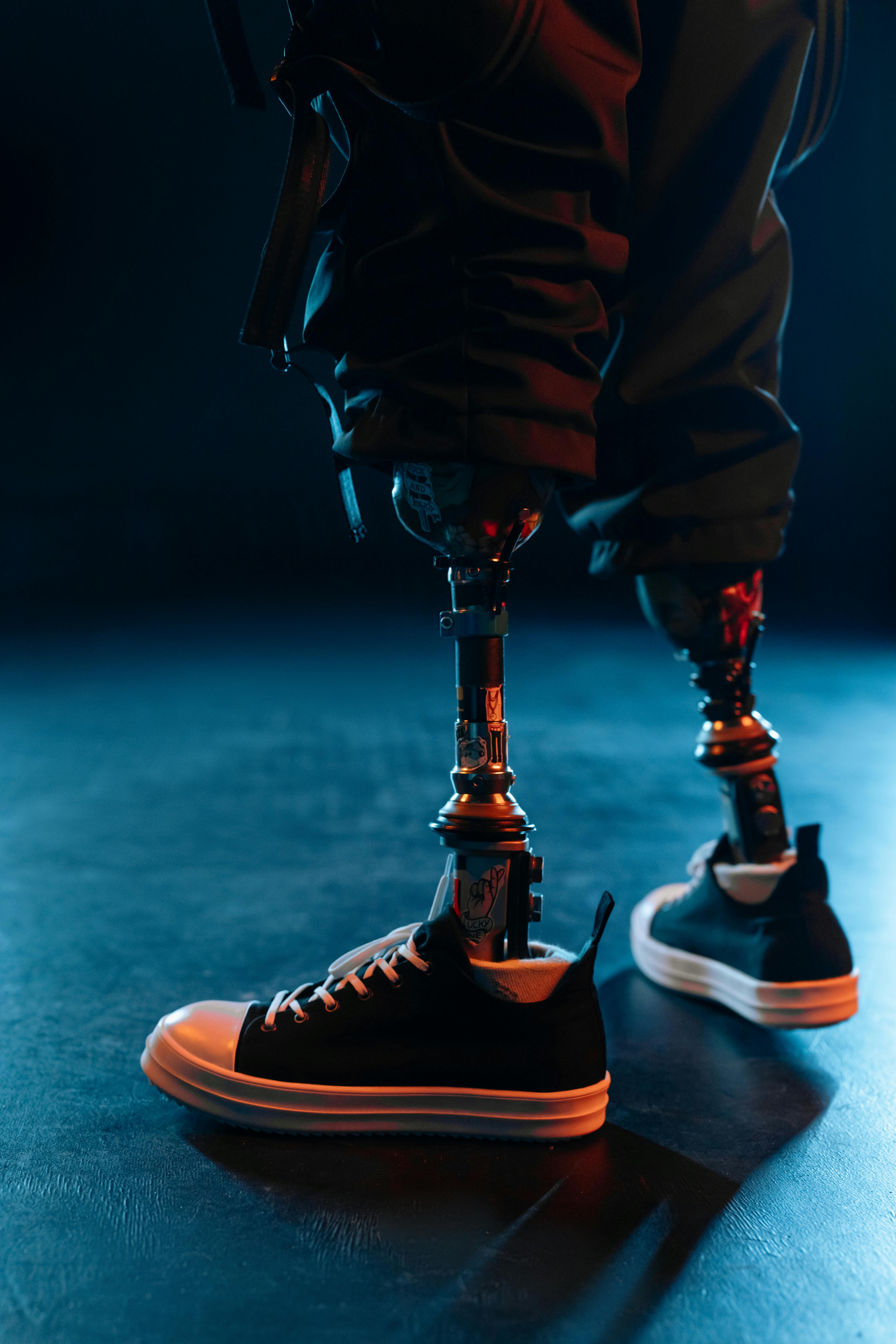 Close-up of prosthetic legs in sneakers, showcasing modern technology and lifestyle.