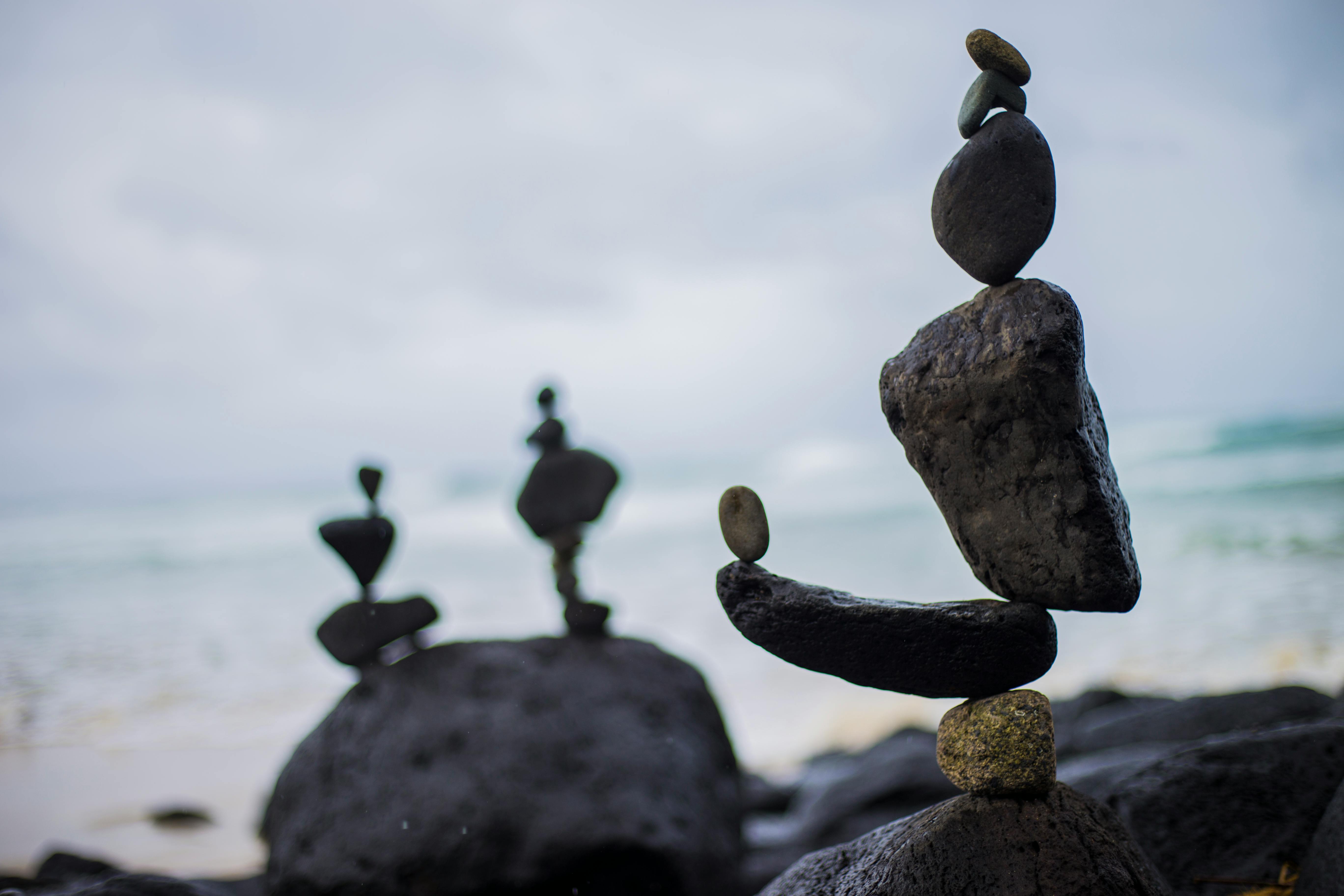 Artistic rock balancing on a serene beach in Fingal Head, NSW, Australia.