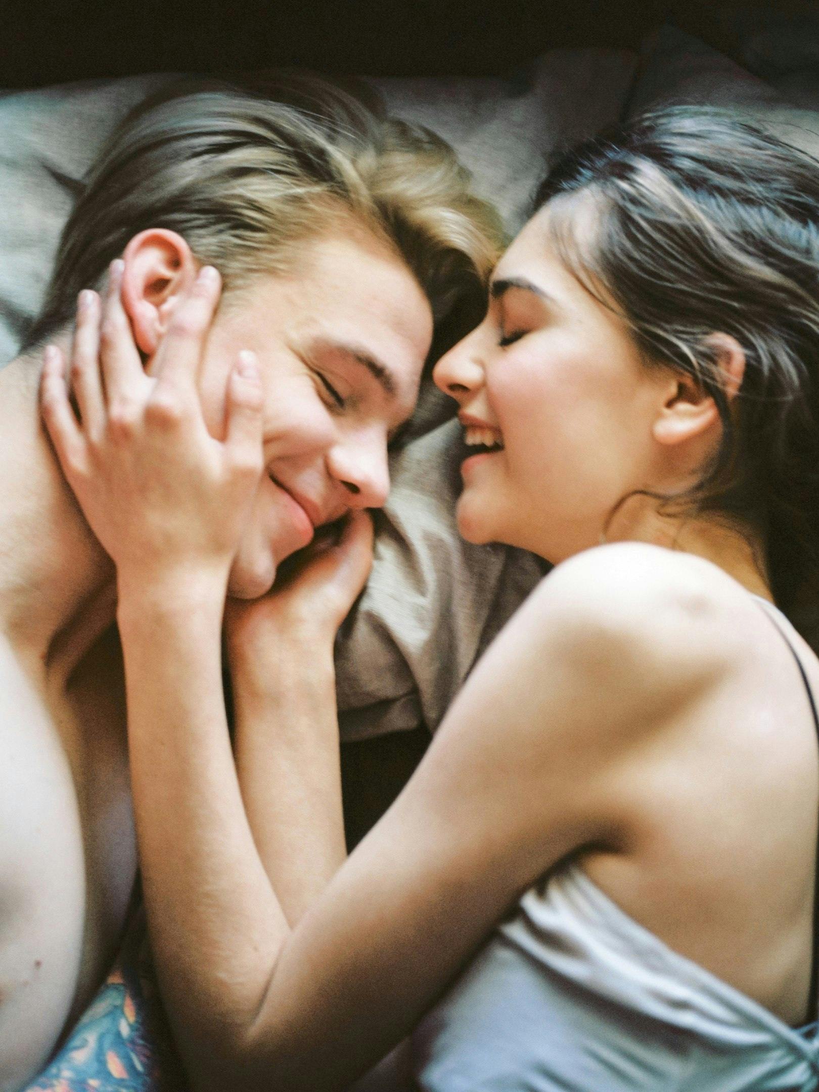 A joyful and intimate moment of a young couple embracing and smiling together.